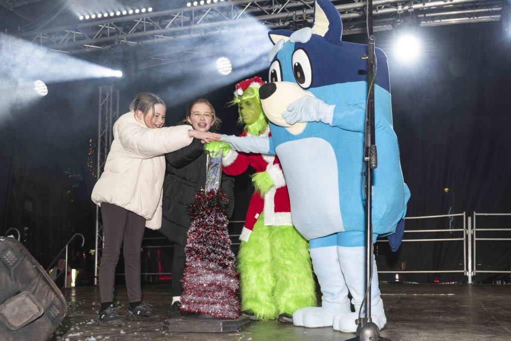 Children from St Jerome's, Bluey and The Grinch switching on the Christmas Lights