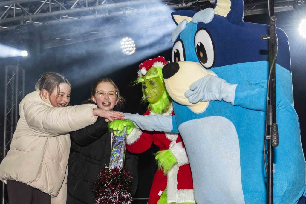 Children from St Jerome's, Bluey and The Grinch switching on the Christmas Lights